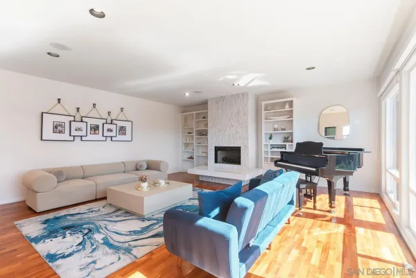 a living room with furniture and a fireplace