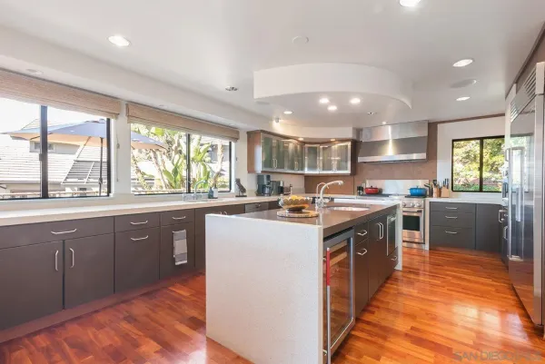 a large kitchen with stainless steel appliances granite countertop a sink and a stove