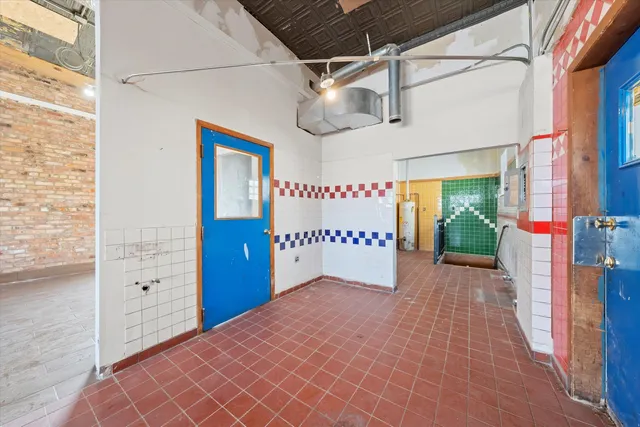 a white toilet sitting next to a white sink