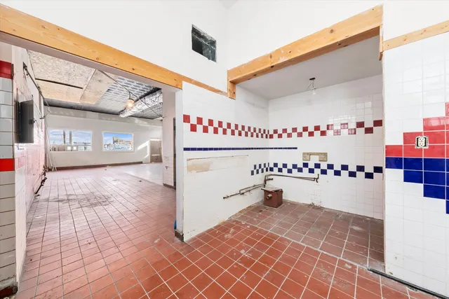 a view of empty room with wooden ceiling
