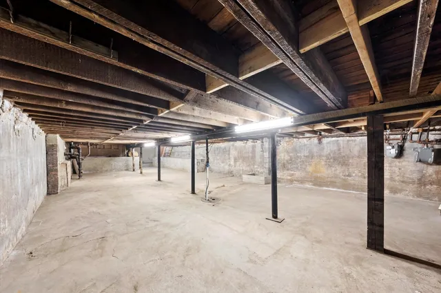 a view of a livingroom with furniture and a large window