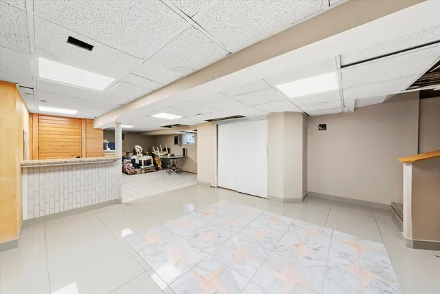 a bathroom with a granite countertop toilet sink and mirror