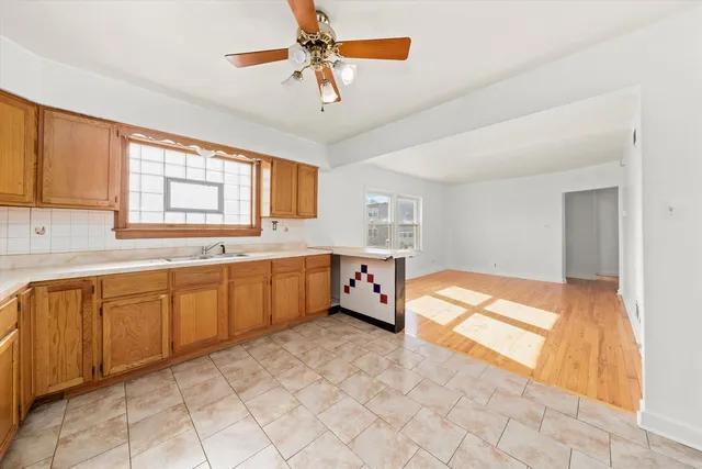 a view of a living room with furniture and a kitchen