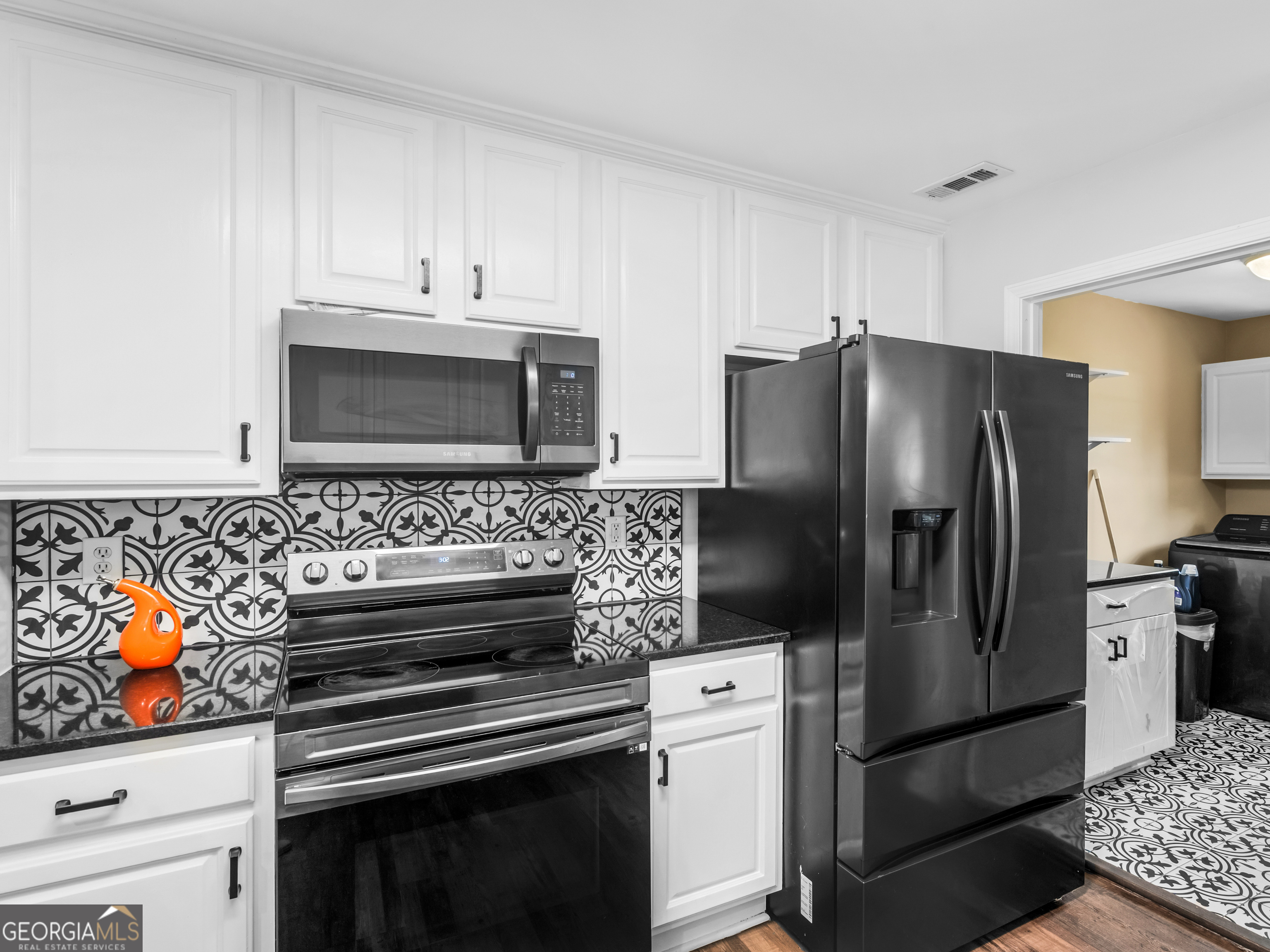 545 Barhams Ridge Drive McDonough, GA 30252 - Photo 23 of 55 a kitchen with stainless steel appliances and chandelier