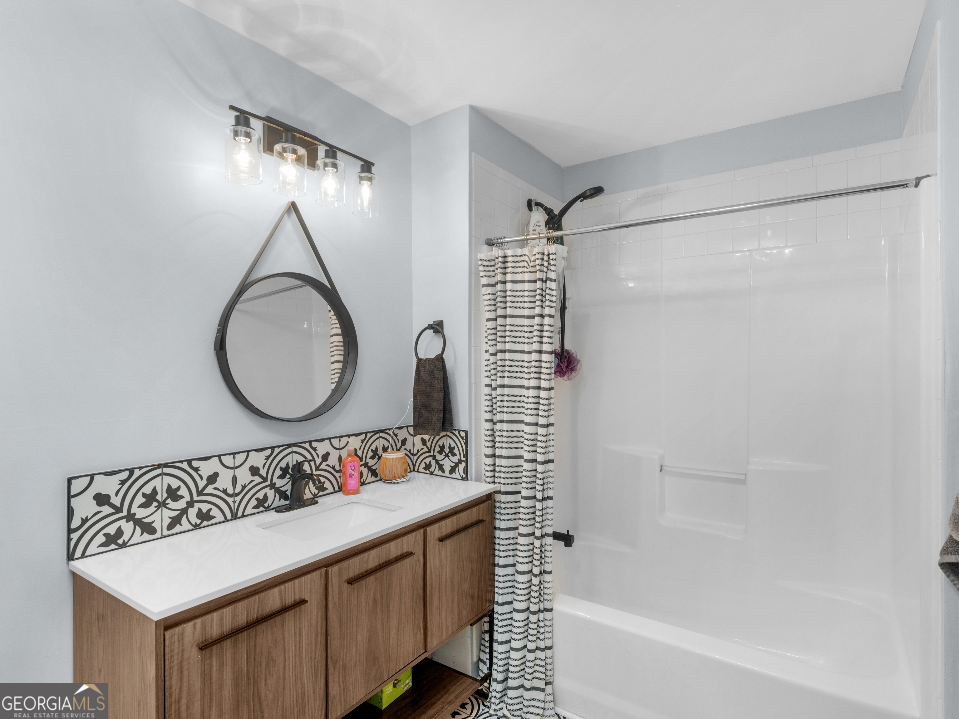 545 Barhams Ridge Drive McDonough, GA 30252 - Photo 37 of 55 a bathroom with a sink mirror vanity and a bathtub