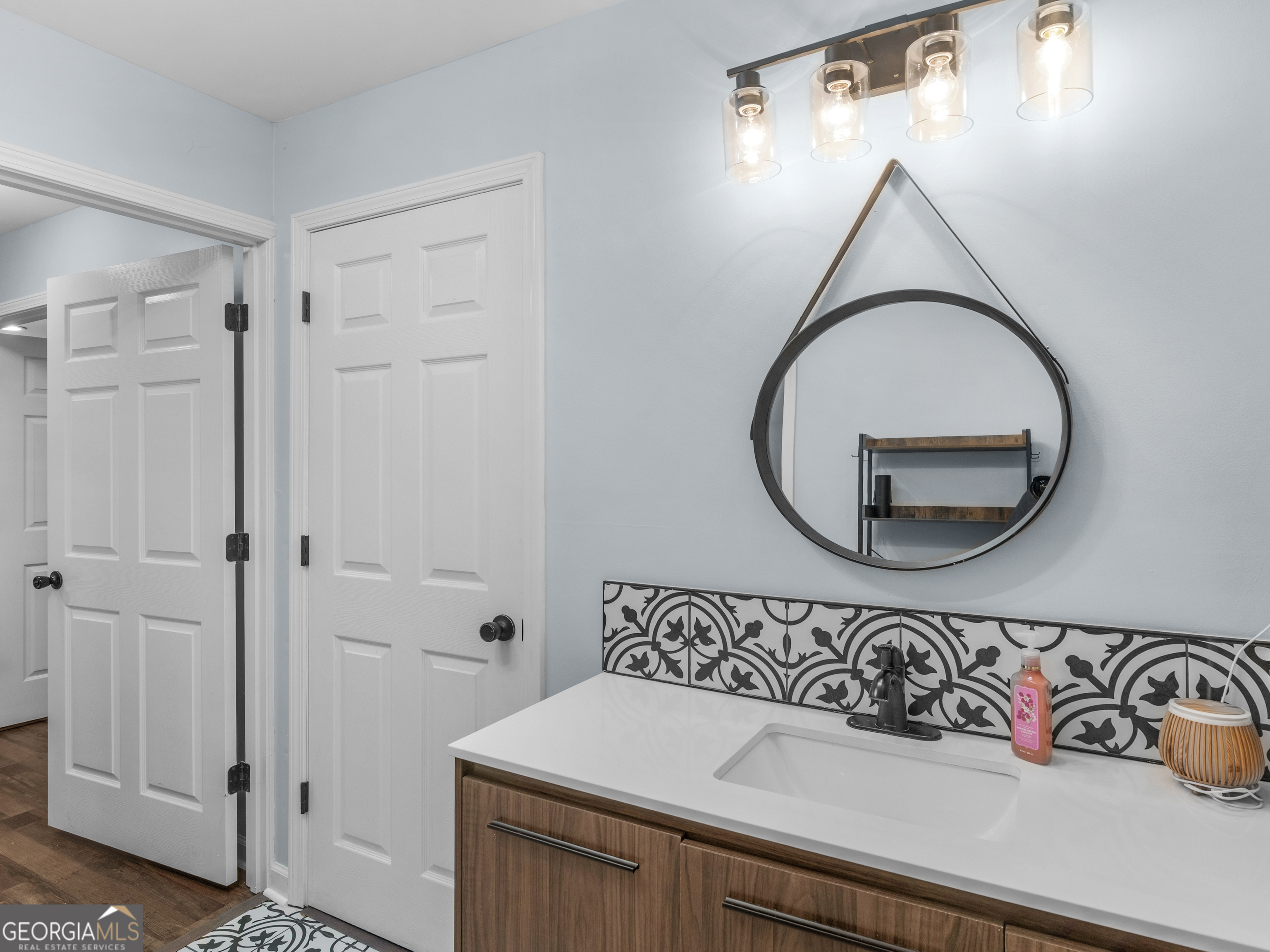 545 Barhams Ridge Drive McDonough, GA 30252 - Photo 38 of 55 a bathroom with a sink and a mirror