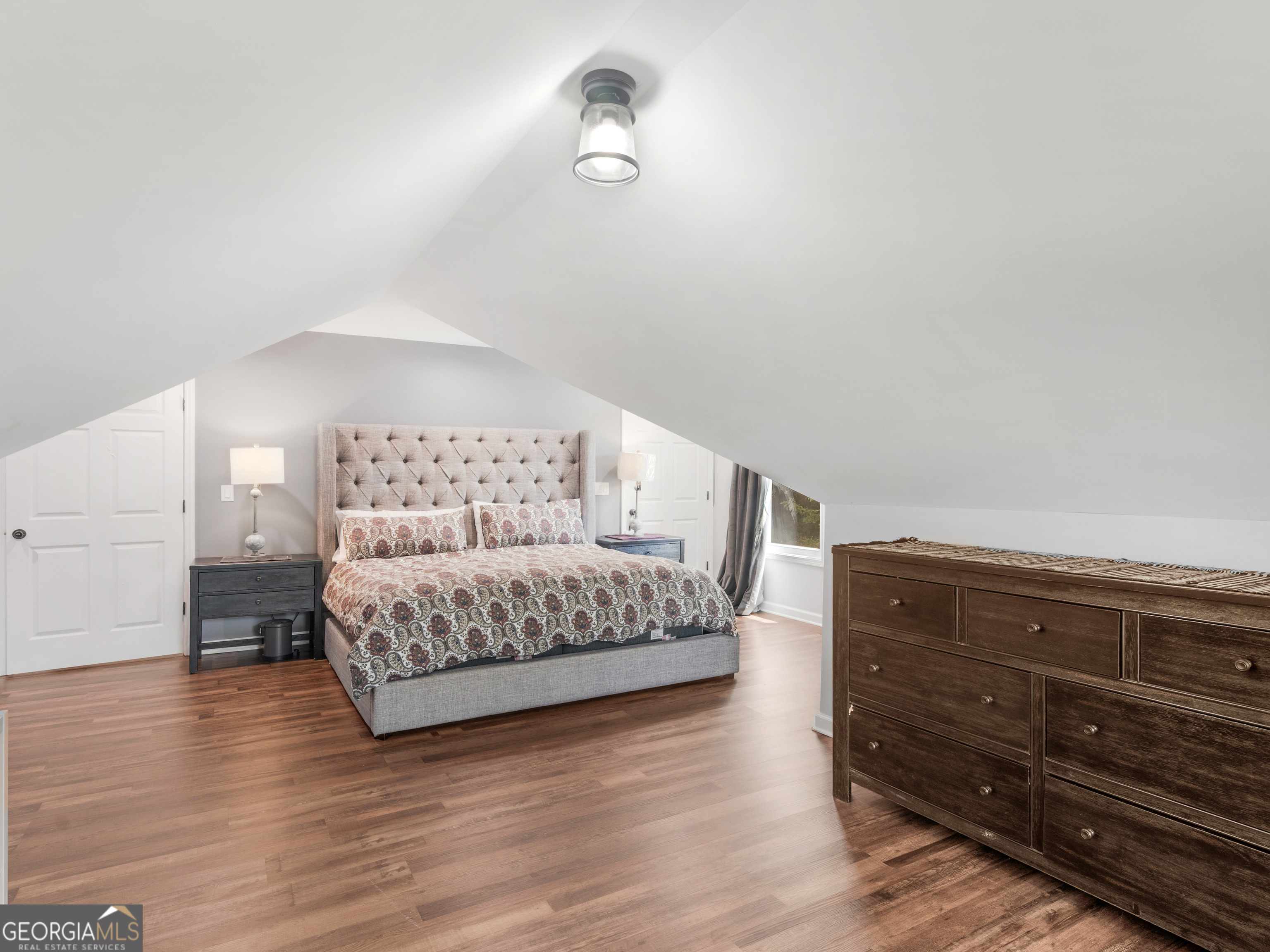 545 Barhams Ridge Drive McDonough, GA 30252 - Photo 45 of 55 a spacious bedroom with a bed and wooden floor