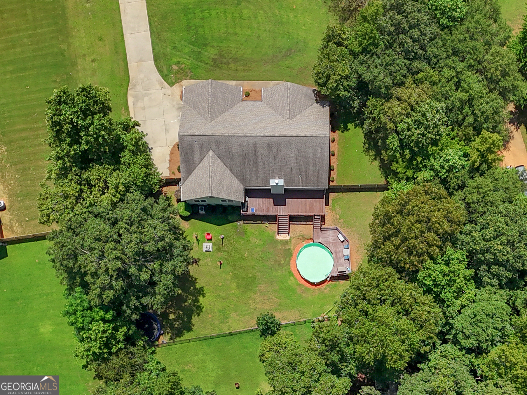 545 Barhams Ridge Drive McDonough, GA 30252 - Photo 55 of 55 an aerial view of a house with a swimming pool a yard and a outdoor seating