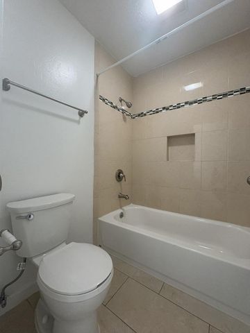 a bathroom with a toilet a sink and shower