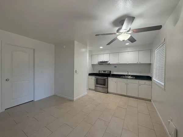 a kitchen with a stove cabinets and a refrigerator