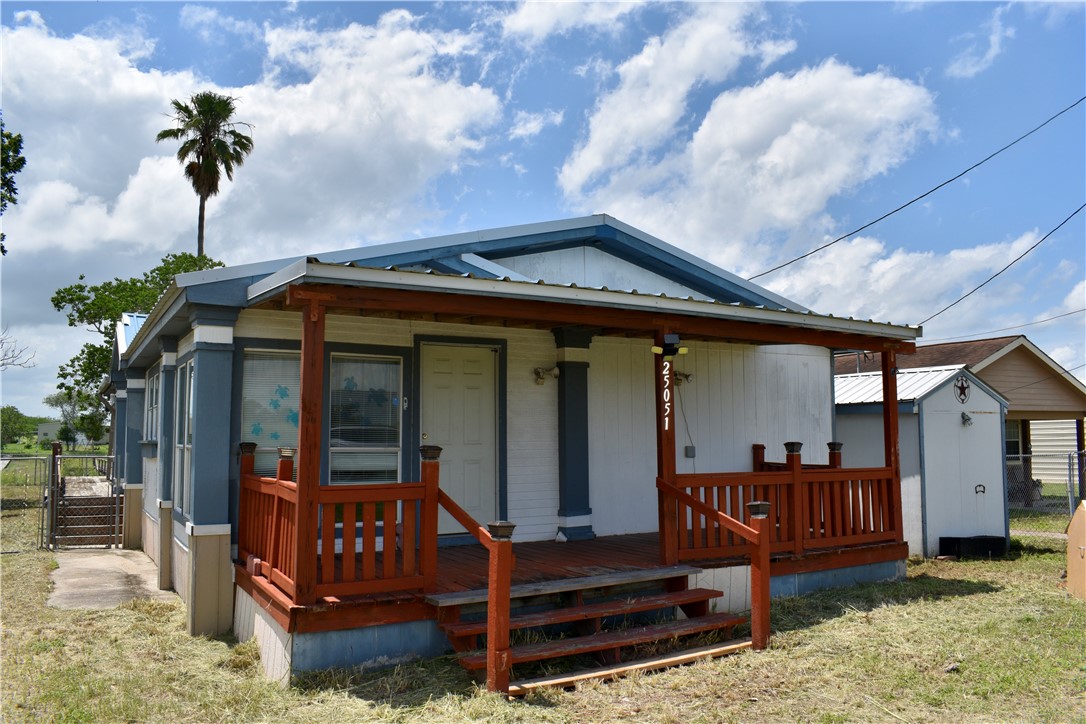 25051 Lake Shore Drive Mathis, TX 78368 - Photo 38 of 40 a front view of a house with balcony and wooden fence