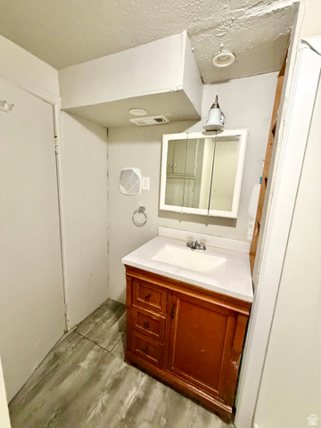7 Foothill Boulevard Pocatello, ID 83204 - Photo 5 of 13 Bathroom featuring a wood-finish vanity with a white countertop and integrated sink