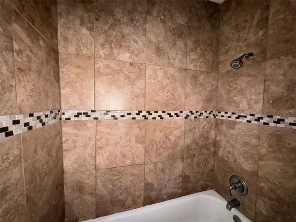 a bathroom with a bathtub and shower