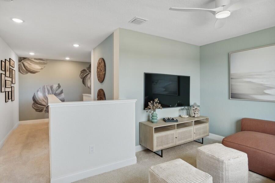 128 Southeast Birch Terrace, Unit 1579 Stuart, FL 34997 - Photo 22 of 44 a living room with furniture and a flat screen tv