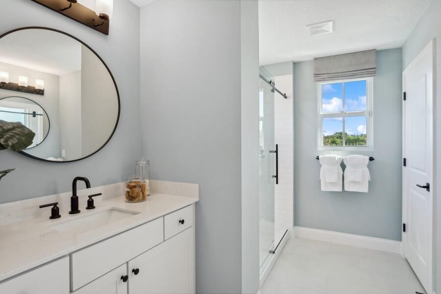 128 Southeast Birch Terrace, Unit 1579 Stuart, FL 34997 - Photo 28 of 44 a bathroom with a sink and a mirror