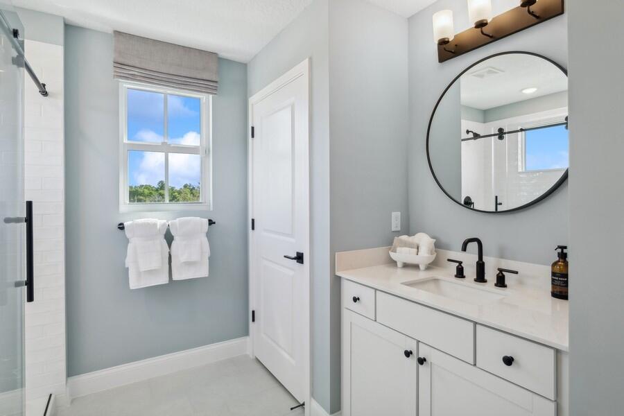 128 Southeast Birch Terrace, Unit 1579 Stuart, FL 34997 - Photo 32 of 44 a bathroom with a sink and a mirror