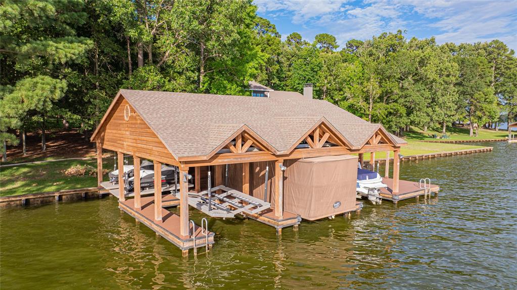 582 Windy Point Mount Vernon, TX 75457 - Photo 7 of 38 Dock featuring boat lift, a water view, and view of scattered trees