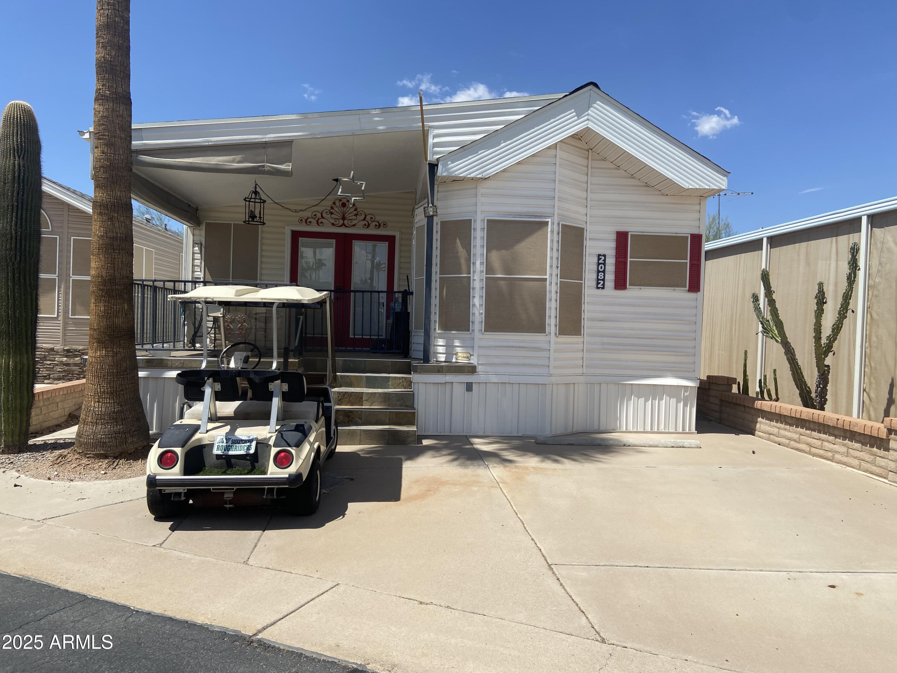 2082 West Klamath Avenue Apache Junction, AZ 85119 - Photo 1 of 4 a view of a patio with table and chairs and potted plants