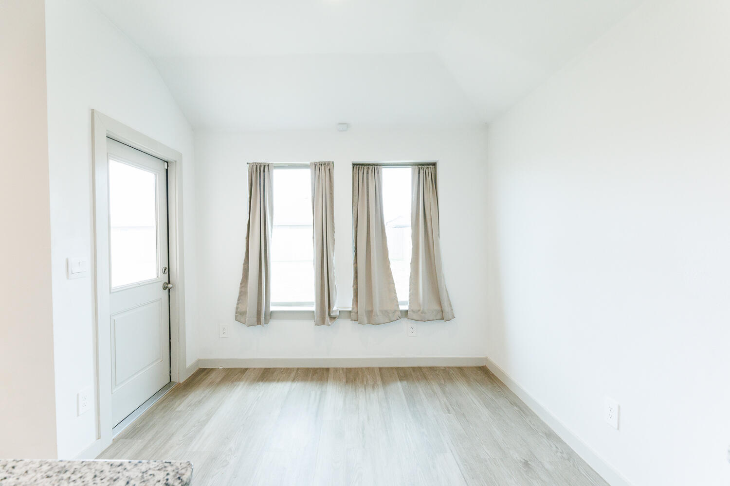 2305 150th Street Lubbock, TX 79423 - Photo 16 of 39 a view of an empty room with wooden floor and a window
