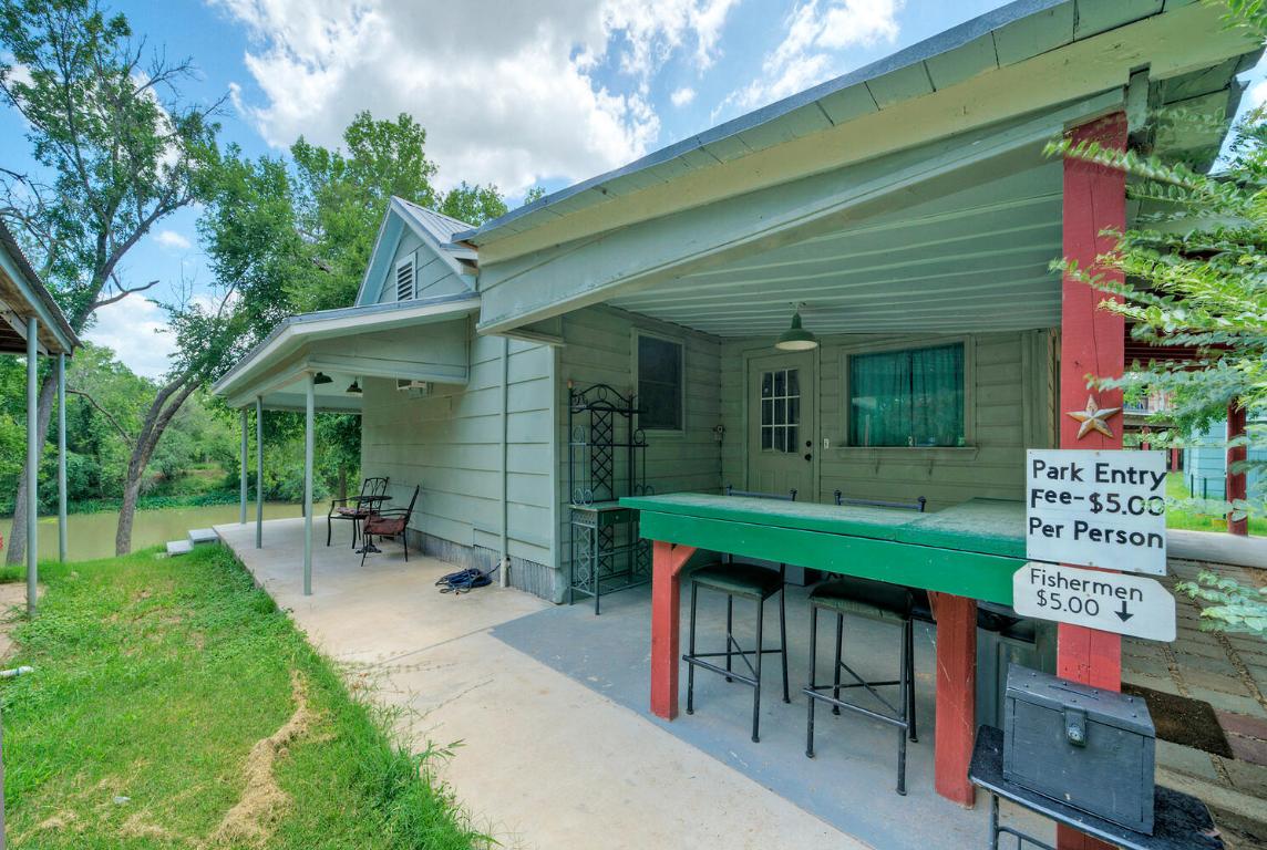906 Water Street Manor, TX 78653 - Photo 6 of 22 an outdoor sitting area with a table and chairs