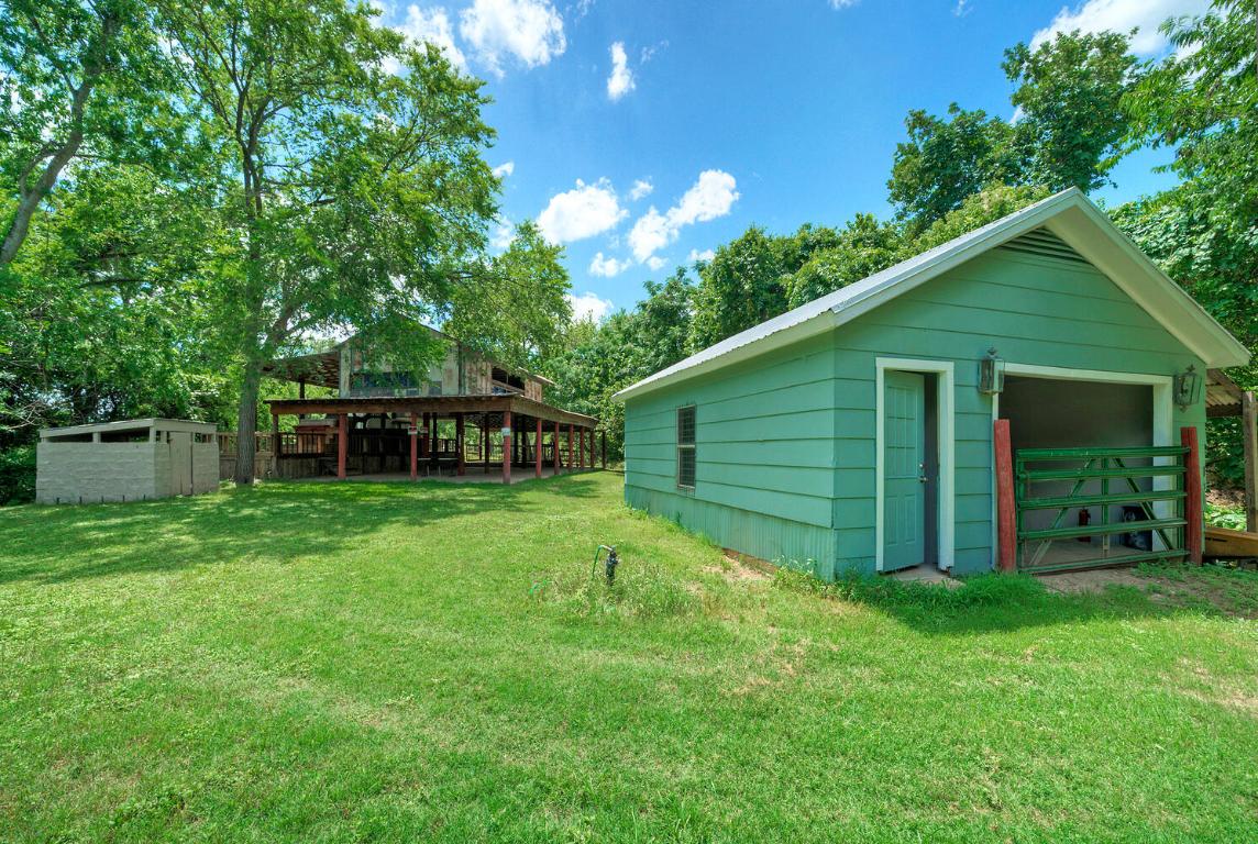 906 Water Street Manor, TX 78653 - Photo 8 of 22 a view of a backyard with plants and large trees
