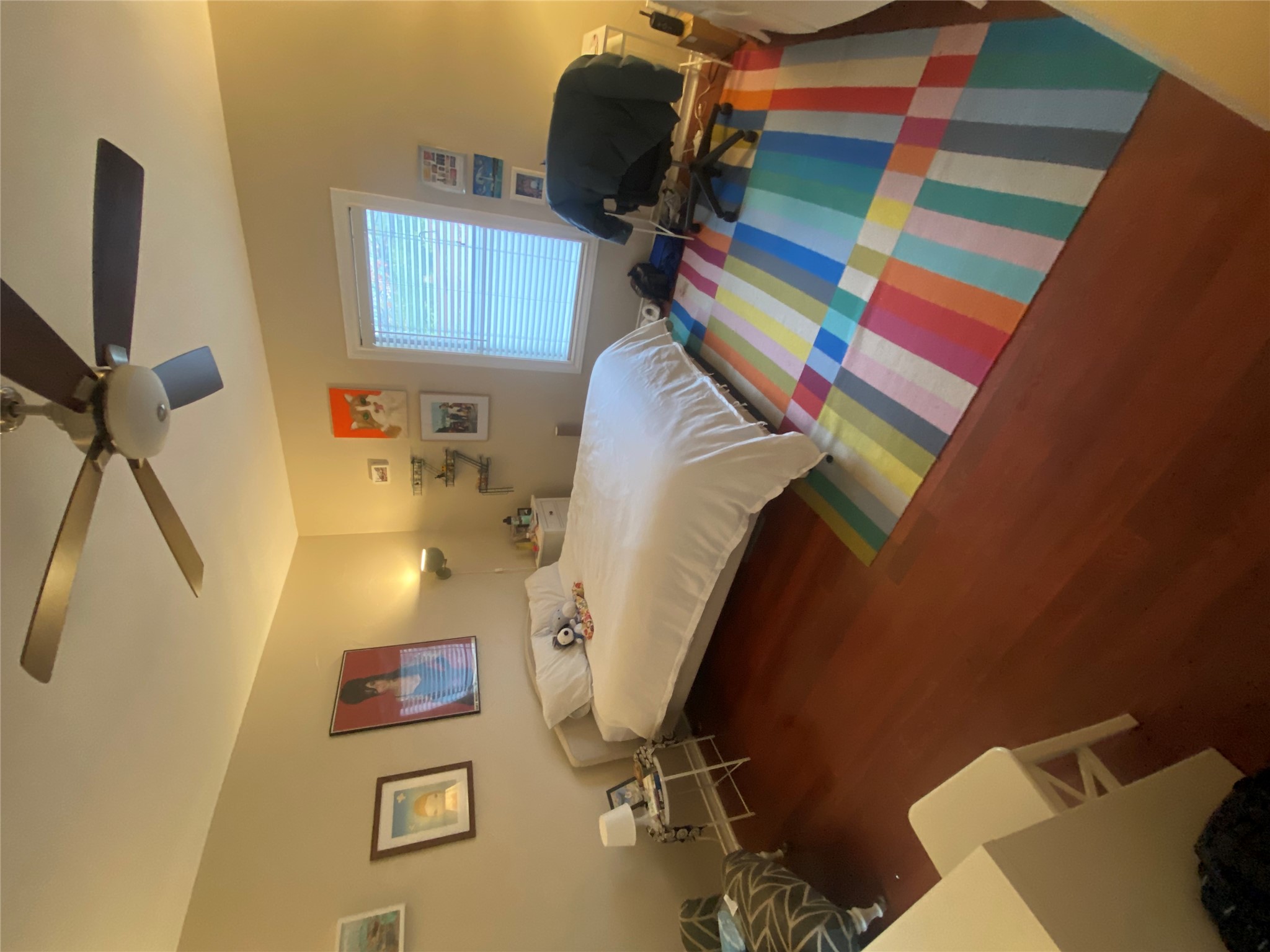 3010 Fruth Street, Unit A Austin, TX 78705 - Photo 22 of 39 Spacious room featuring wood-finish flooring, a ceiling fan with integrated lighting, and a window with blinds