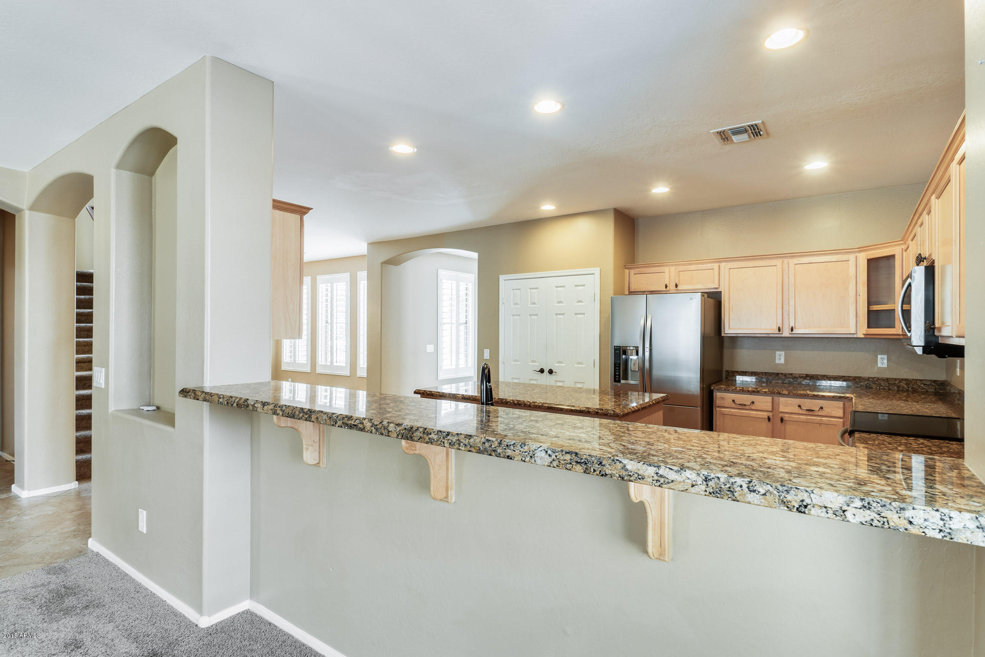 3250 East Blue Ridge Way Gilbert, AZ 85298 - Photo 18 of 44 a large kitchen with a large counter top and sink