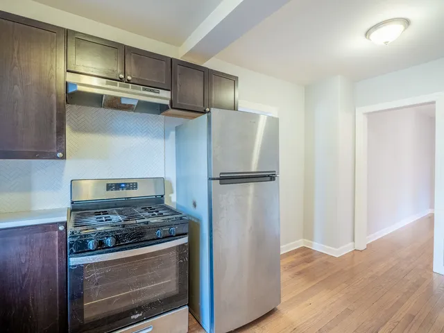 a kitchen with cabinets and stainless steel appliances
