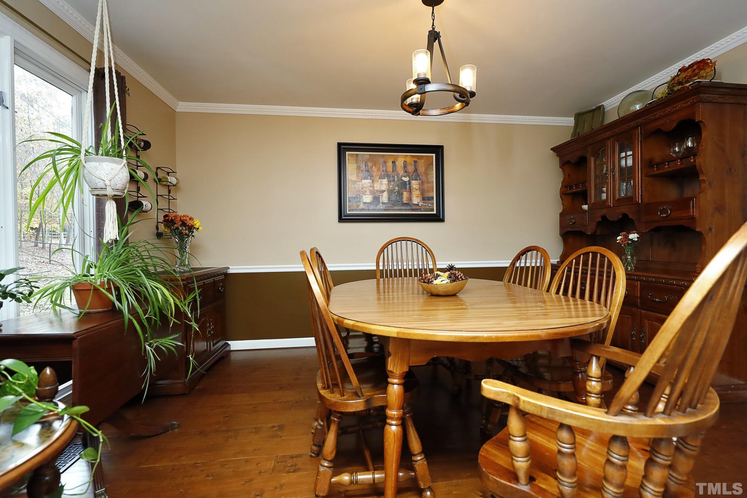 10904 Brass Kettle Road Raleigh, NC 27614 - Photo 16 of 41 a view of a dining room with furniture and chandelier
