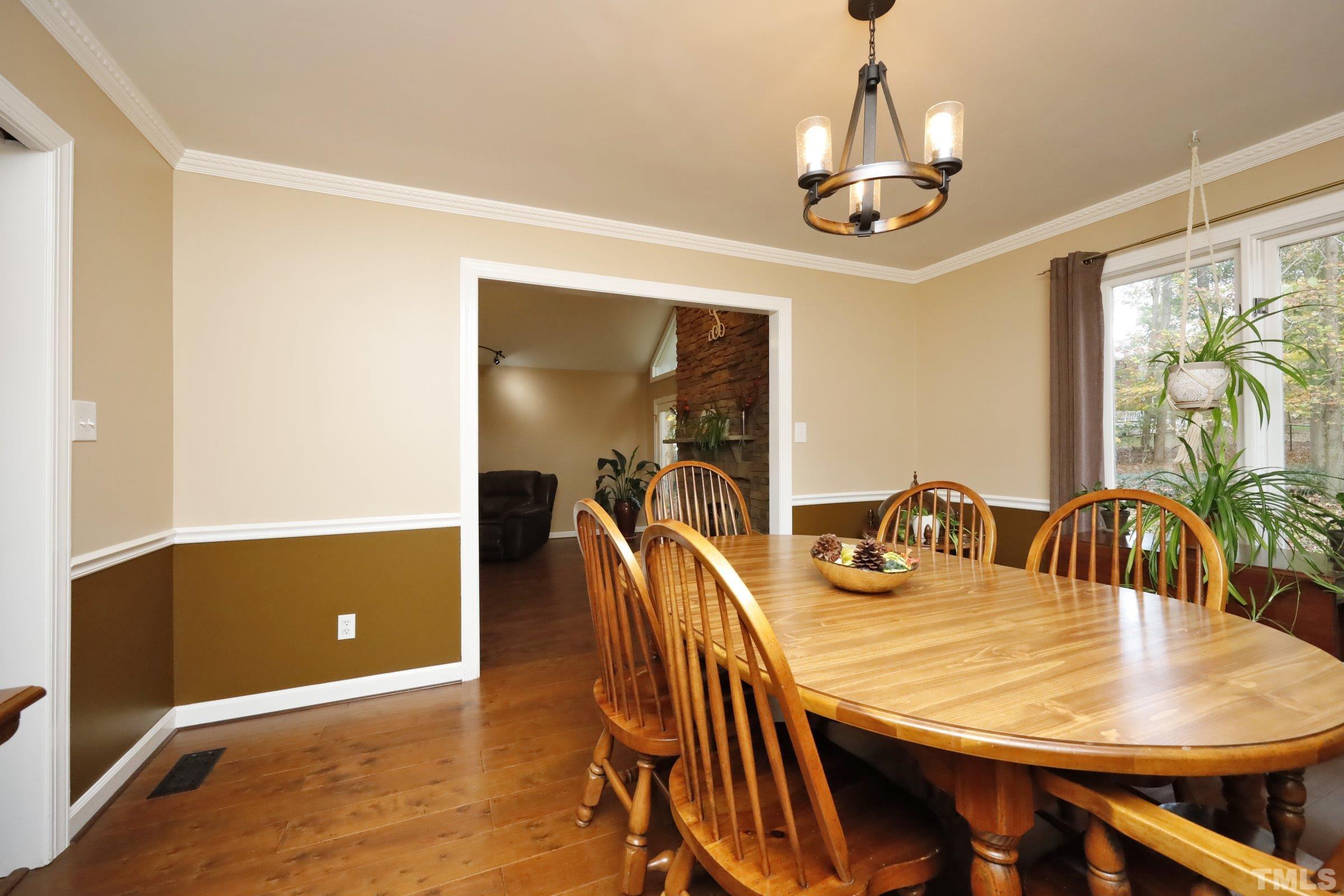 10904 Brass Kettle Road Raleigh, NC 27614 - Photo 17 of 41 a view of a dining room with furniture and wooden floor