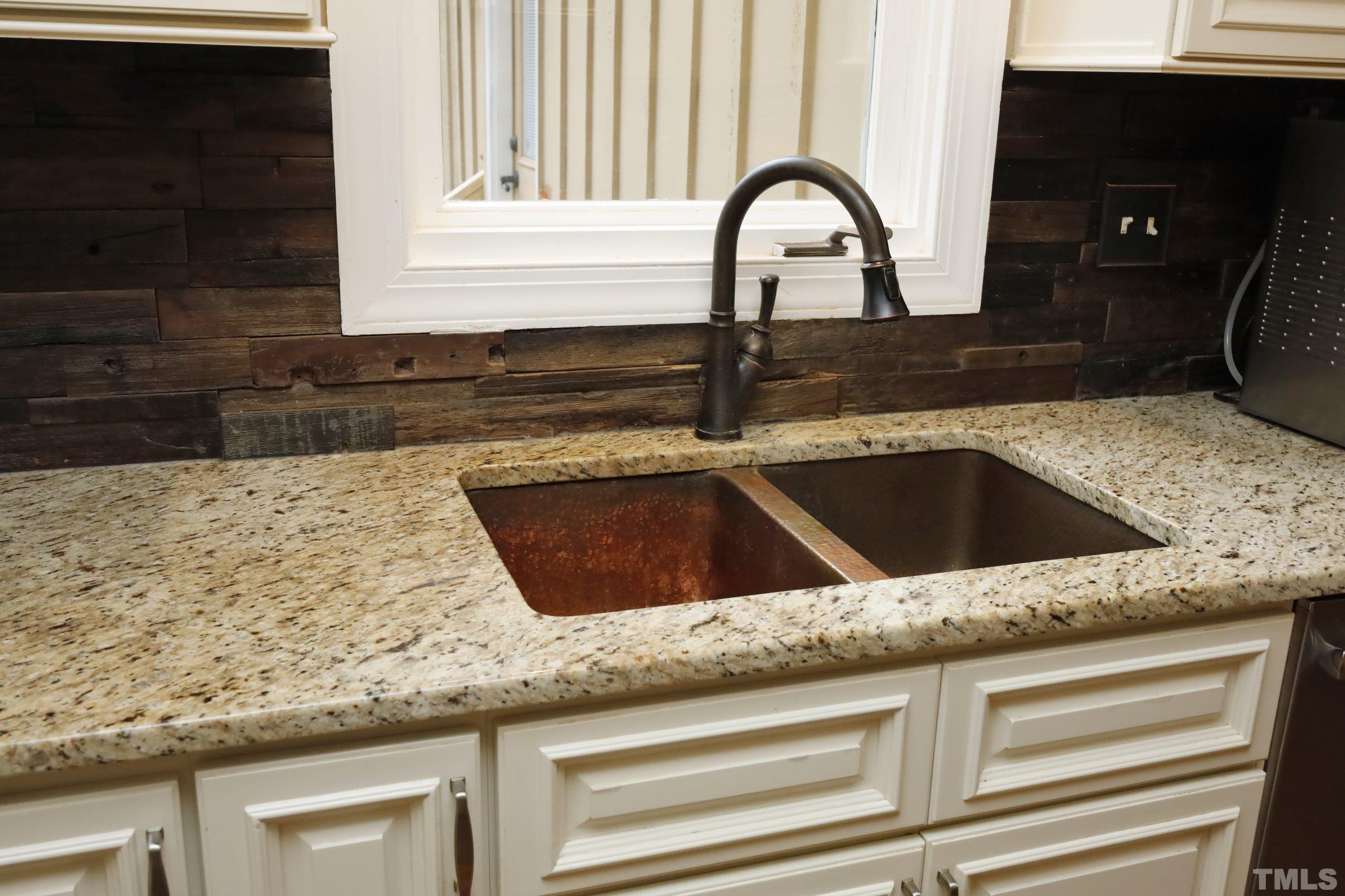10904 Brass Kettle Road Raleigh, NC 27614 - Photo 23 of 41 a close view of a sink and dishwasher with kitchen island