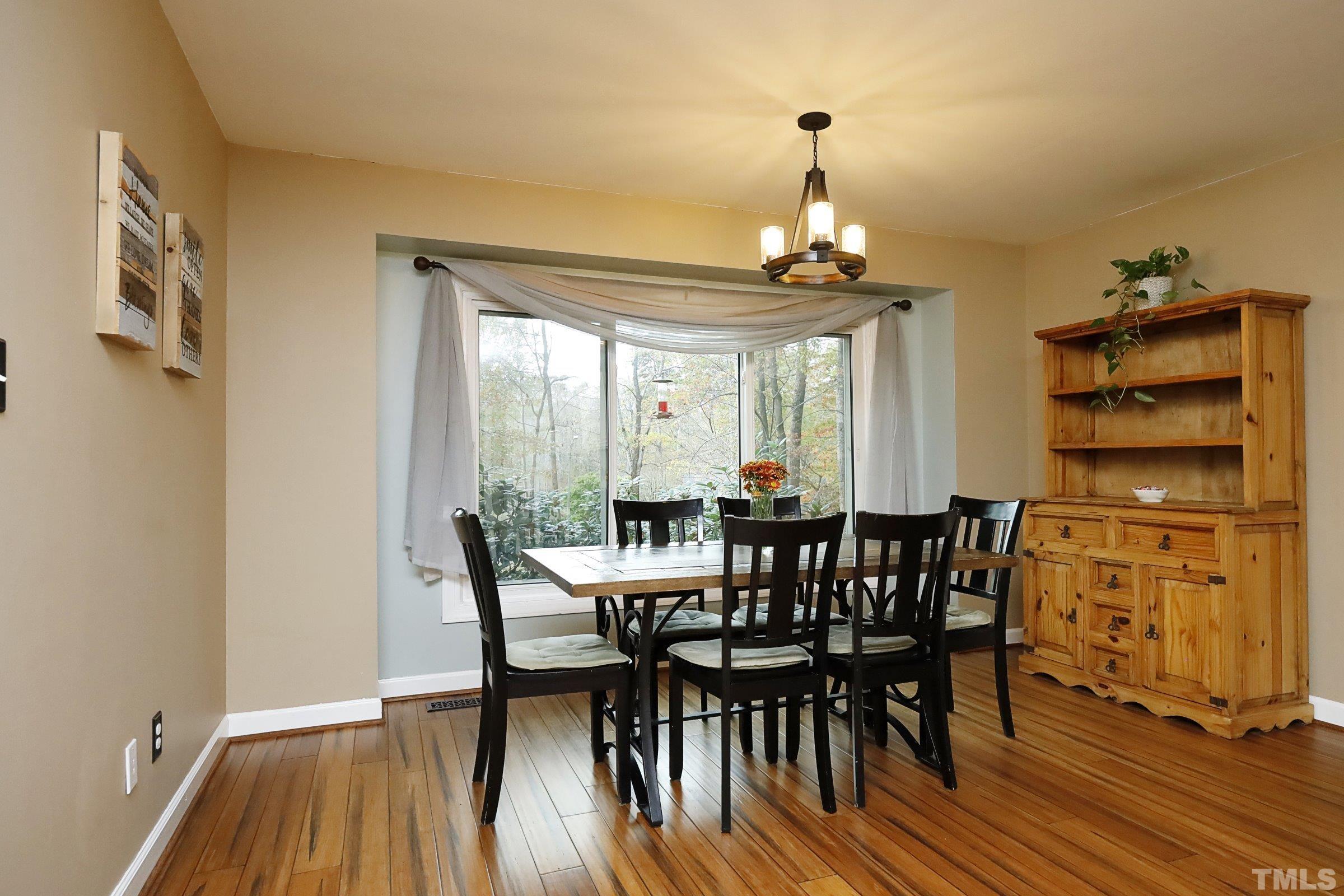 10904 Brass Kettle Road Raleigh, NC 27614 - Photo 25 of 41 a view of a dining room with furniture window and wooden floor
