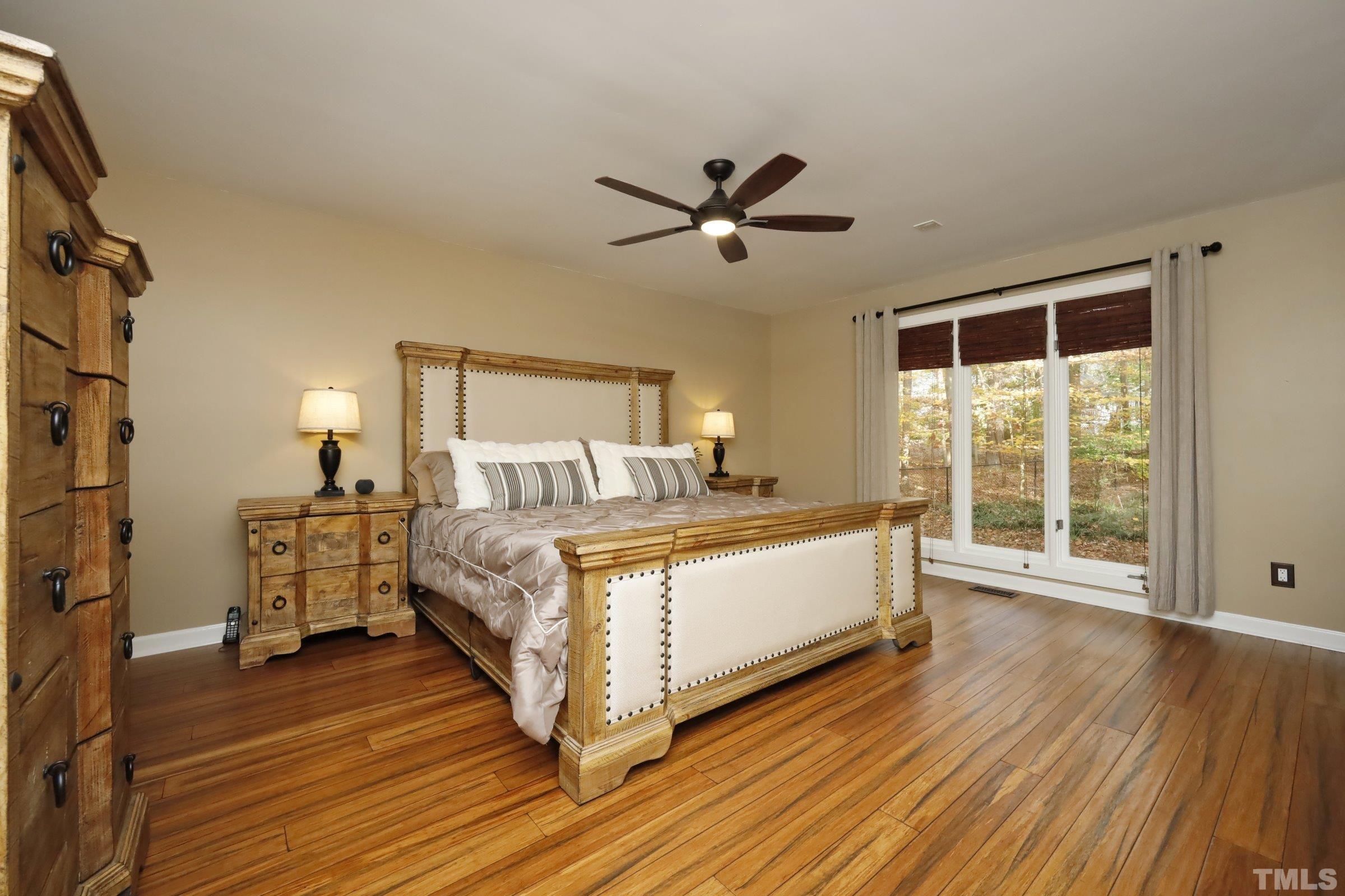 10904 Brass Kettle Road Raleigh, NC 27614 - Photo 28 of 41 a bed room with a bed and a large window