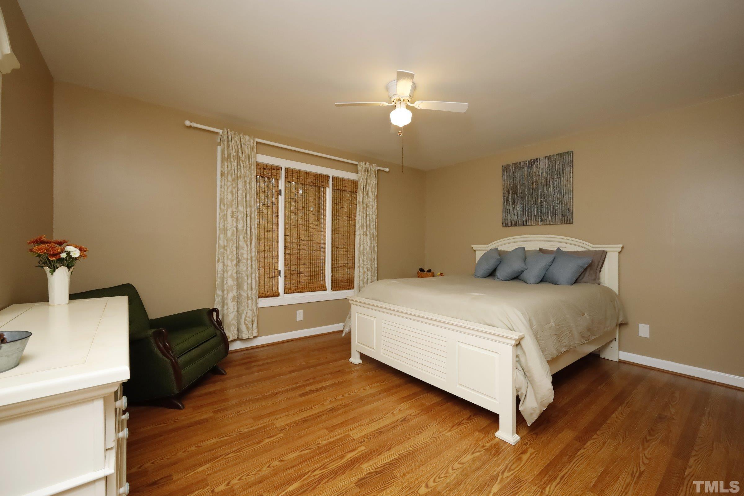 10904 Brass Kettle Road Raleigh, NC 27614 - Photo 30 of 41 a bedroom with a bed and wooden floor