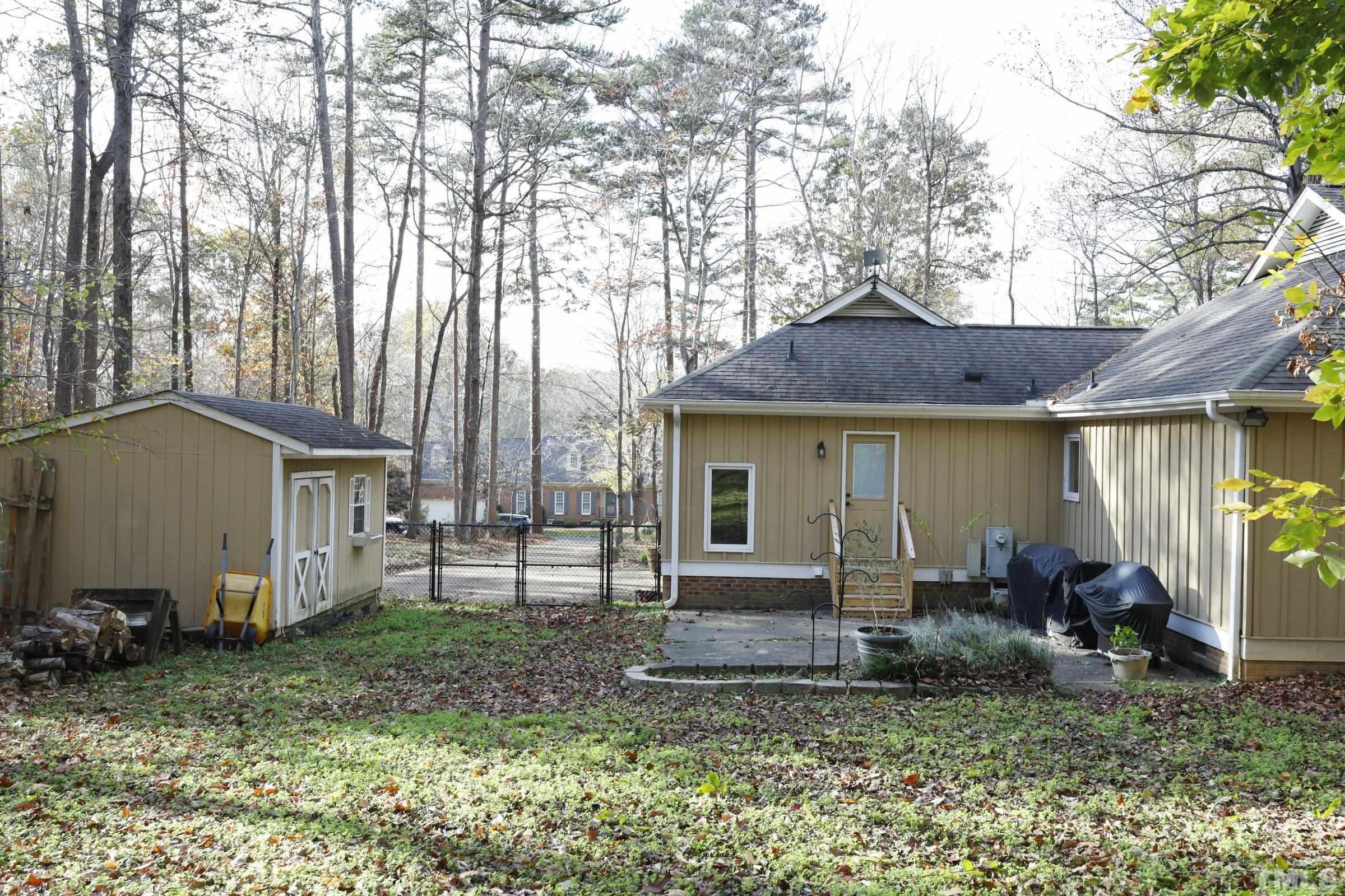 10904 Brass Kettle Road Raleigh, NC 27614 - Photo 36 of 41 a view of a house with backyard and chair