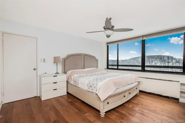 a bedroom with a bed and large window