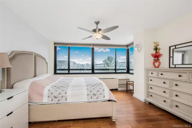 a bedroom with a large bed and a chandelier