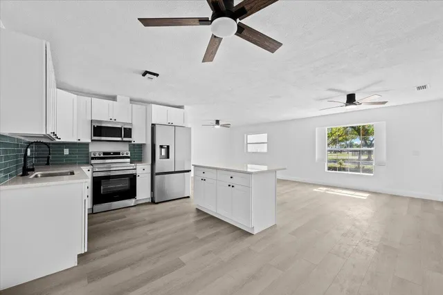 a kitchen with stove cabinets and wooden floor