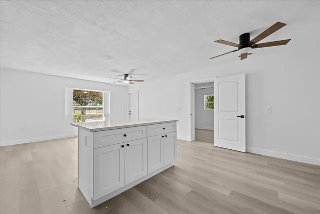 a spacious bathroom with a double vanity sink a large mirror and shower