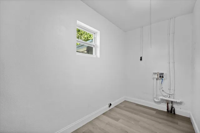 a view of a room with wooden floor and window