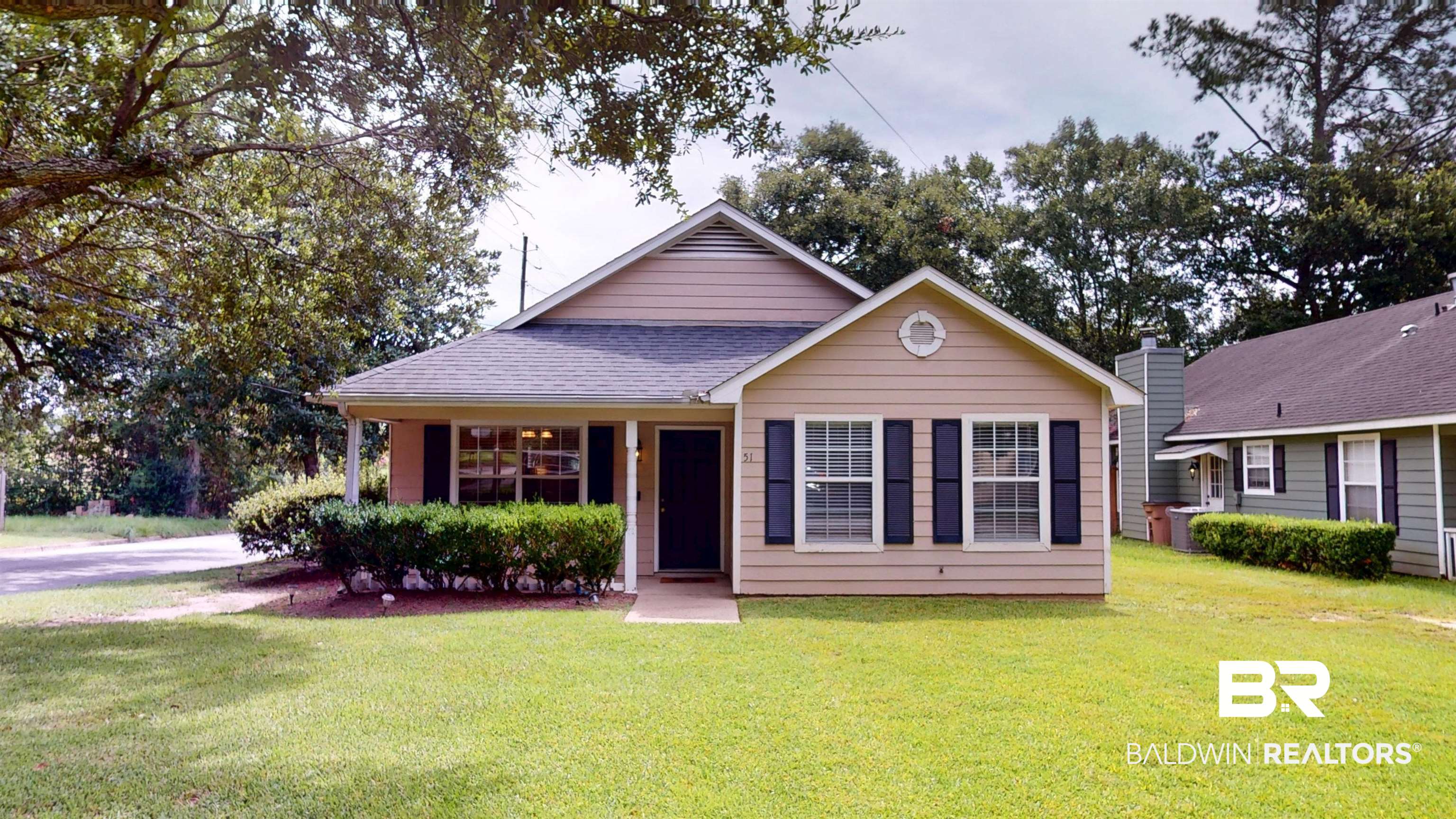 51 Bishop Lane South Mobile, AL 36608 - Photo 2 of 19 View of front of home featuring a front yard, covered porch, and roof with shingles