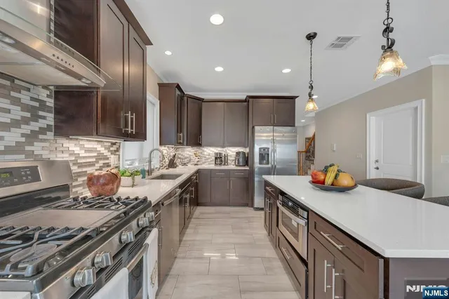a kitchen with a sink stove and refrigerator