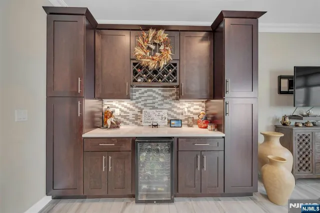 a kitchen with stainless steel appliances sink and wooden floor