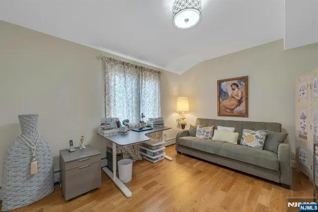 a room with a table chairs and a view of bedroom