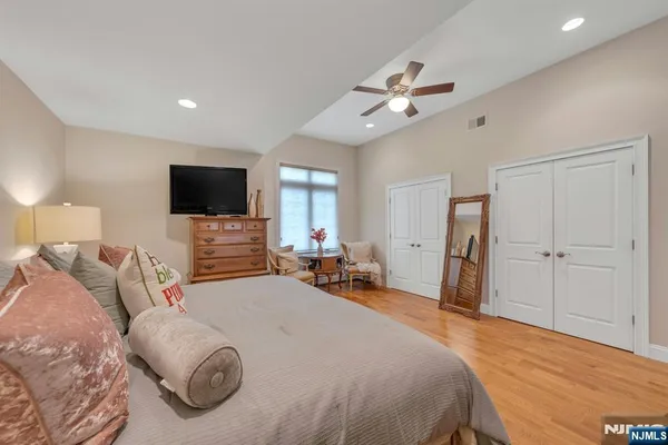 a bathroom with a granite countertop sink mirror and a bath tub