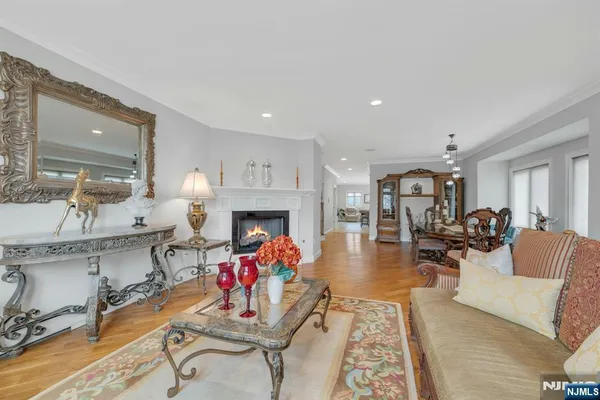 a view of a dining room and livingroom with furniture wooden floor a chandelier