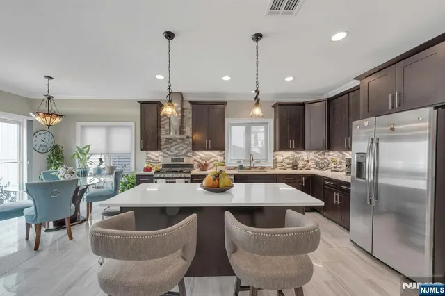 a kitchen with a sink a stove and chairs