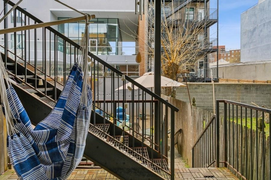 412 Monroe Street, Unit 2 Hoboken, NJ 07030 - Photo 12 of 16 a view of balcony with wooden floor and fence