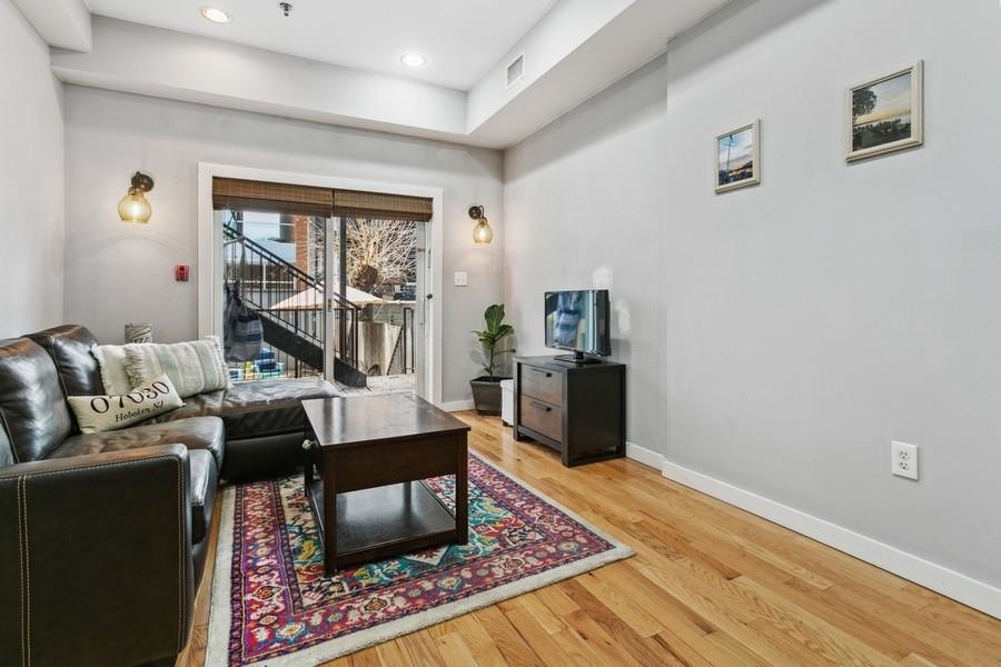 412 Monroe Street, Unit 2 Hoboken, NJ 07030 - Photo 3 of 16 a living room with furniture rug and window