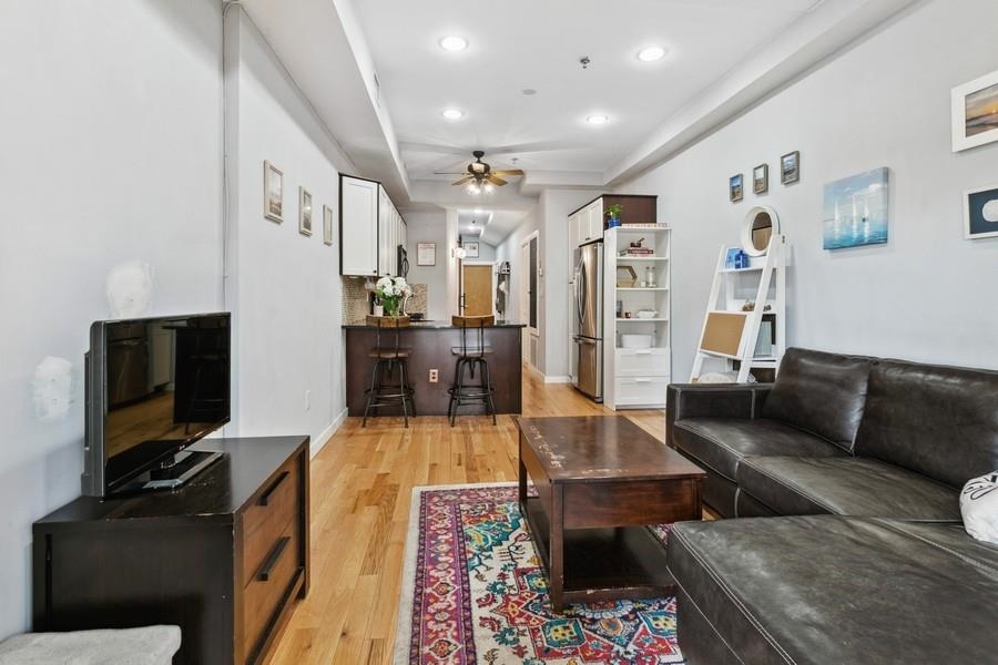 412 Monroe Street, Unit 2 Hoboken, NJ 07030 - Photo 5 of 16 a living room with furniture and a flat screen tv